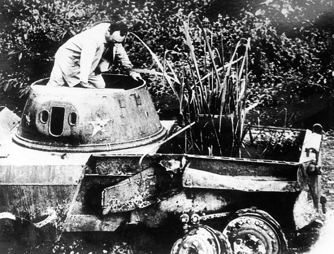 Auf dem Wrack eines Panzerwagens bei der französischen Dschungelfestung Dien Bien Phu